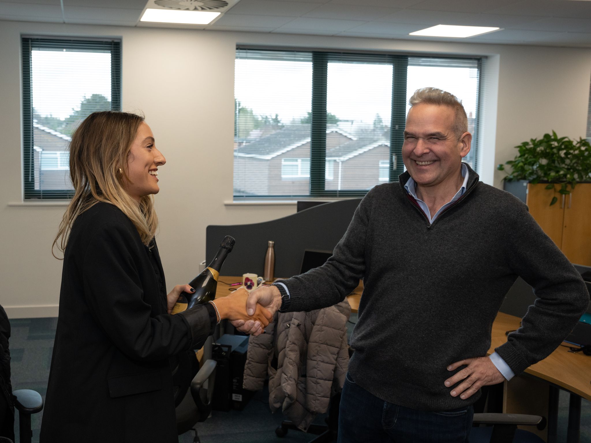 Andrew Try congratulating a comxo employee